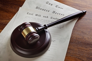 A judge’s gavel rests on top of legal documents, including a divorce decree and a last will and testament—key paperwork when contesting a will—on a wooden desk. A judge's gavel rests on top of legal documents, including a divorce decree and a last will and testament—key paperwork when contesting a will—on a wooden desk.
